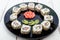 Traditional eastern dish with salmon, shrimp - sushi rolls on a black plate