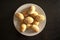 Traditional eastern mamoul cookies. Top view. Arabic baked sweets on white plate on dark wooden table