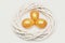 Traditional eggs painted in golden color inside woven wooden wreath