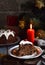 Traditional english Christmas steamed pudding with winter berries, dried fruits, nut in festive setting with Xmas tree and burning