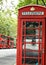 Traditional English Red Telephone Phone Box and Red Double Decker Buses London England