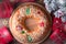 Traditional Epiphany cake Roscon de Reyes on wooden table top with small Christmas tree, wrapped gifts and decoration