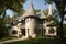 traditional exterior of tudor-style house, complete with turret, cast stone columns and decorative half-timbering