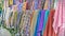 Traditional fabric store with stacks of colorful textiles, fabric rolls at market stall - textile industry background with blurred
