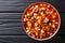 Traditional fagioli soup with vegetables, ditalini pasta and ground beef closeup in a bowl. Horizontal top view