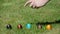 Traditional family Easter game with painted eggs on grass