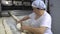 Traditional family Italian bakery. A woman baker prepares bread for baking.