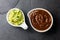 Traditional famous mexican sauces chocolate chili mole poblano, and avocado guacamole on slate gray background