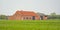 Traditional farm along a meadow and forest  in the flemsh countryside