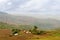 Traditional farm in the ring road region of Cameroon, Africa with mountains in the distance