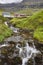 Traditional Faroe village of  Kunoy with picturesque stream. Faroese tourism