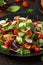 Traditional fattoush salad on a plate with pita croutons, cucumber, tomato, red onion, vegetables mix and herbs