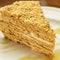 Traditional festive honey cake on the white plate closeup