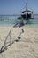 A traditional Filipino boat or Outrigger at Island on sunny day and anchored on a sandy be