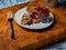 Traditional Finnish cuisines closeup of a liver caseroll dish on a plate with fresh lingonberries on the side