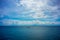 Traditional fisherboat sailing on water with cloudy sky