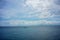 Traditional fisherboat sailing on water with cloudy sky