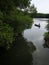 a traditional fisherman paddling boat at the river