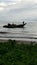 Traditional fishermen start to go fishing. Old wooden fishing boat is cruising out