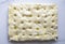 Traditional focaccia dough made from flour, water, yeast, sugar, salt water, and olive oil holes - top view, cooking process on a