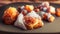 Traditional French beignets doughnuts with orange zest and powdered sugar on a grey textured background, selective focus