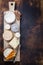 Traditional French cheese platter with Spanish dulce de membrillo on a burnt wooden board
