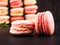 traditional french colorful macarons, dark background