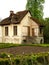 Traditional French Cottage with Thatched Roof and Garden