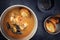 Traditional French fish bouillabaisse soup with prawns and mussels in a modern design bowl