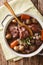 Traditional French food: Coq au vin with wine and vegetable