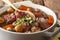 Traditional French food: Coq au vin with wine and vegetable