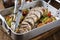 Traditional French lamb rolled roast sliced with potatoes and vegetables in a design aluminum pan