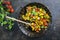 Traditional French ratatouille with vegetable and potatoes in a rustic wrough-iron skillet