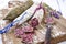 Traditional French salami with camembert and lavender on a wooden board