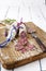 Traditional French salami with camembert and lavender on a wooden board