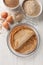 Traditional French Savory Buckwheat Galettes Bretonnes pancakes on a table with flour, cereal and eggs closeup on the wooden table