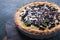 Traditional french sweet fruit dessert clafoutis with  blueberries on blue  concrete background. Healthy gluten free food concept