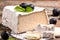 Traditional French veined soft white goat cheese with cut wedge piece. Valencay cheese with berries on a wooden background