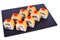 Traditional fresh japanese sushi rolls on black stone Syake Cheese on a white background. Roll ingredients: salmon, philadelphia