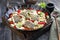 Traditional fried Greek cod fish filet casserole with feta cheese and vegetable in a rustic wrought iron pan