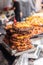 Traditional fried potato pancakes piled up at the vendor during a street food market