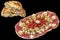 Traditional Garnished Savory Appetizer Dish with Leavened Flatbread Torn Loaf Isolated on Black Background