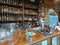 Traditional general store bar. Shelves with beverage bottles, cash register. Automobile Museum.