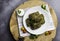 Traditional georgian dolma in grape leaves on rustic wooden table with copyspace