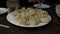 Traditional Georgian Khinkali dumplings served on a white plate on dining table