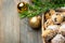 Traditional German Austrian Swiss Christmas pastry mini stollen cakes or cookies in wicker basket and on wood table golden balls