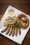 Traditional german bavarian meal of sausages with sauerkraut and pretzel
