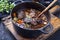 Traditional German braised beef cheeks in brown red wine sauce with carrots and onions in a cast iron Dutch oven