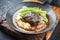 Traditional German braised veal cheeks in brown sauce with mashed potatoes and beans