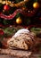Traditional German Christmas cake Stollen on a rustic festive table. Celebration decorations.